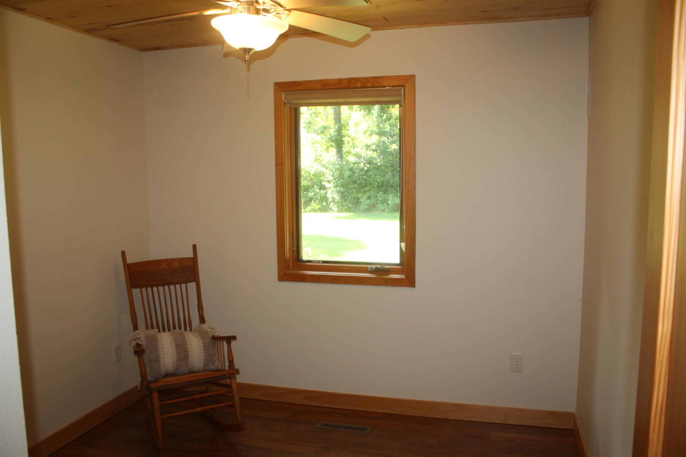 8611 South Lyman Lake Road South Range, WI 54874 - Photo 30 of 41 Unfurnished room with wooden ceiling, dark wood-style floors, and ceiling fan