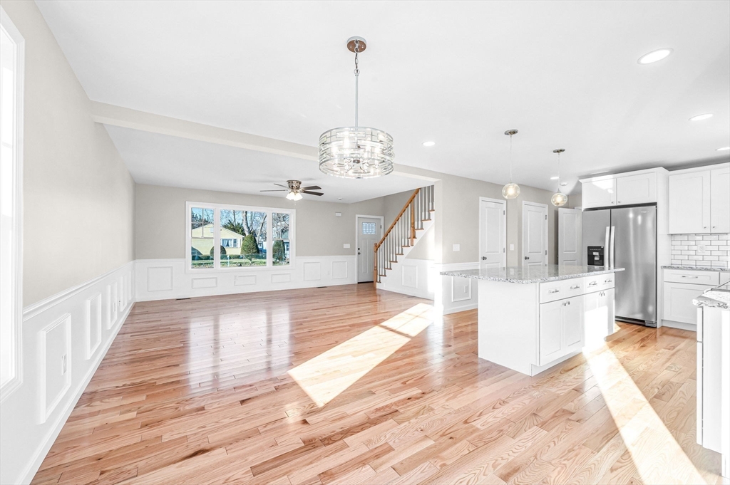 39 Wallace Street Springfield, MA 01119 - Photo 14 of 41 a view of a hallway with wooden floor and a chandelier
