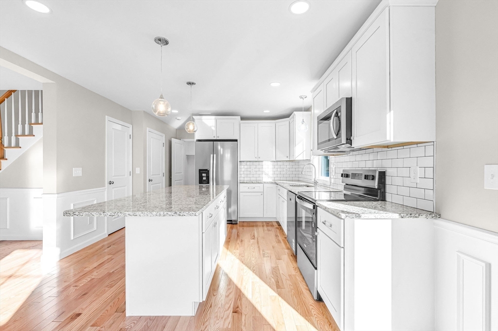 39 Wallace Street Springfield, MA 01119 - Photo 16 of 41 a kitchen with stainless steel appliances kitchen island granite countertop a sink stove and refrigerator