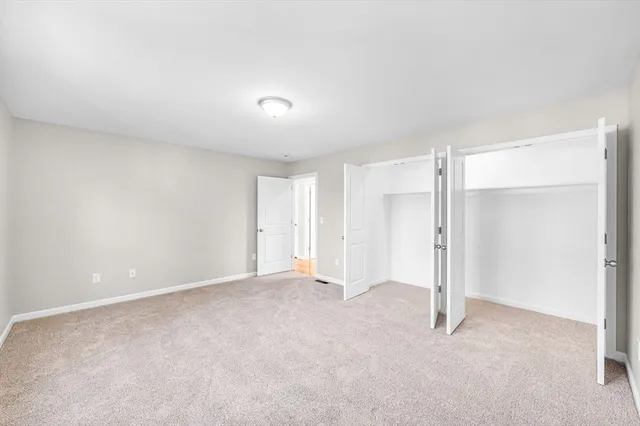 a bedroom with a large bed and a large window