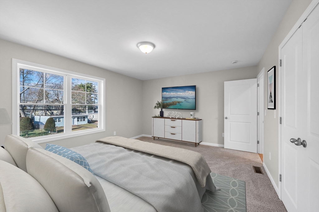 39 Wallace Street Springfield, MA 01119 - Photo 28 of 41 a bedroom with a large bed and a large window