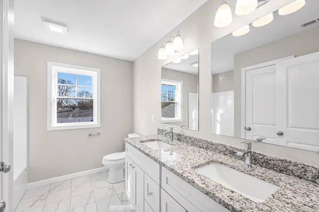 a bathroom with a granite countertop sink mirror and shower