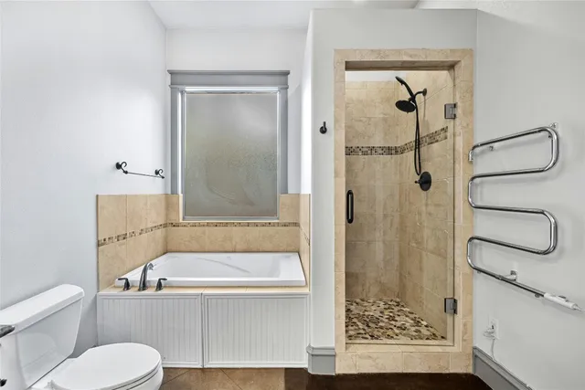 a bathroom with a toilet and a shower