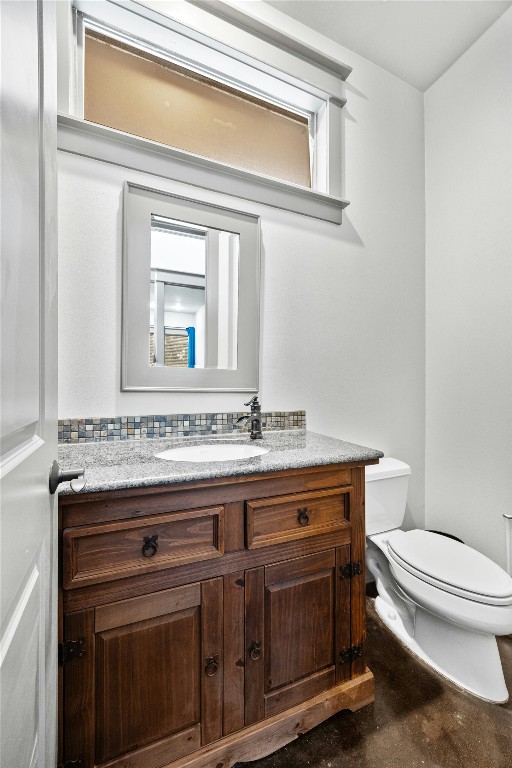 5617 Clay Avenue, Unit B Austin, TX 78756 - Photo 20 of 38 a bathroom with a granite countertop toilet sink and mirror