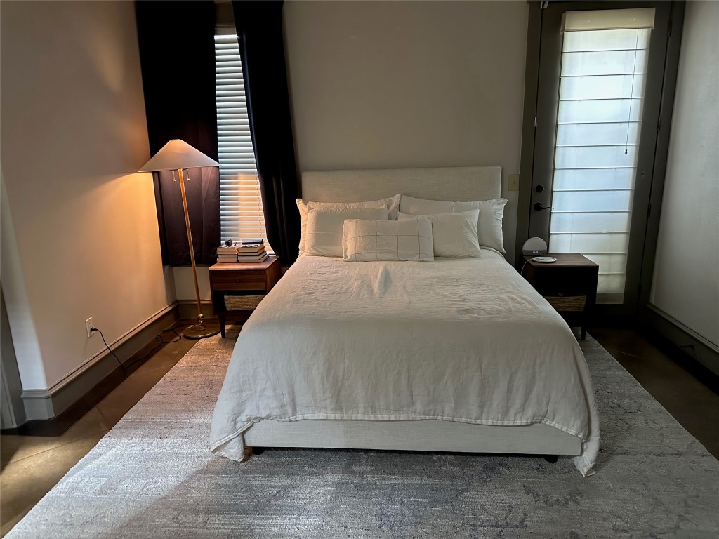 5617 Clay Avenue, Unit B Austin, TX 78756 - Photo 37 of 38 a bedroom with a bed and wooden floor