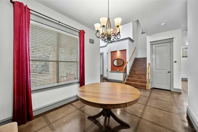 a view of a dining room with furniture and a chandelier