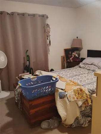 a bed sitting in a bedroom next to a bathroom