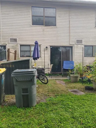 a view of a house with backyard and sitting area
