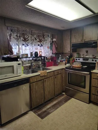 a kitchen with a stove and cabinets