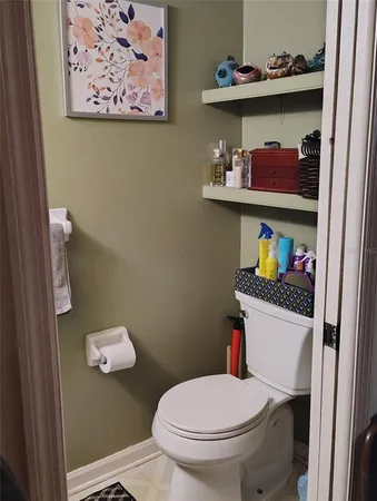 a white toilet sitting next to a bathroom sink