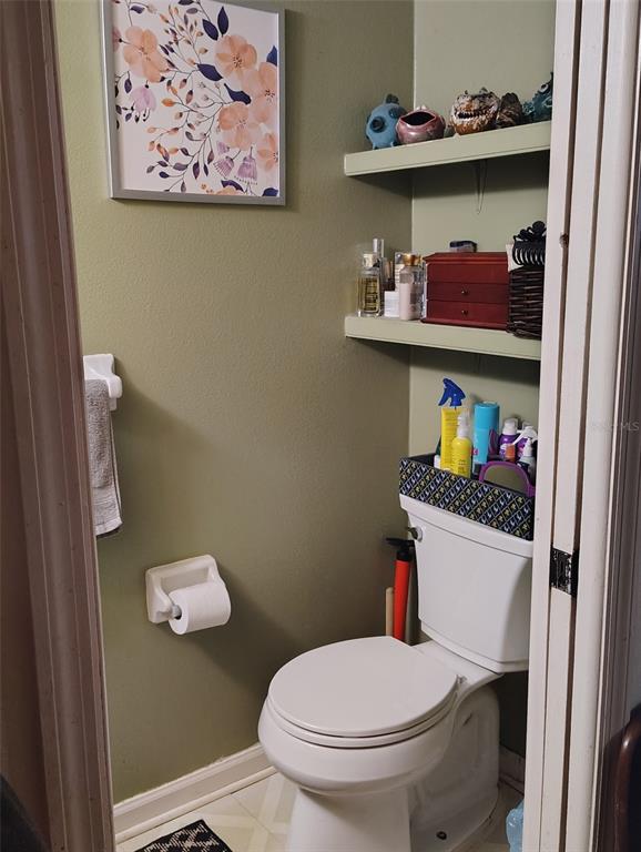 2962 Morgan Combee Road Lakeland, FL 33801 - Photo 8 of 14 a white toilet sitting next to a bathroom sink