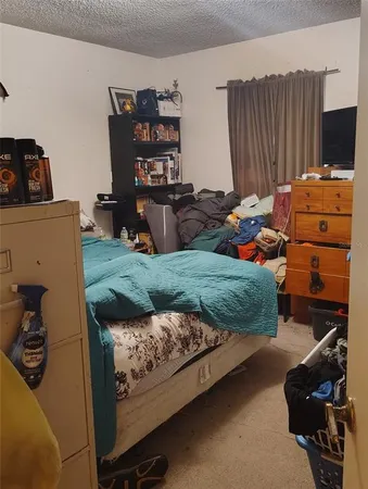 a bedroom with bed and a book shelf