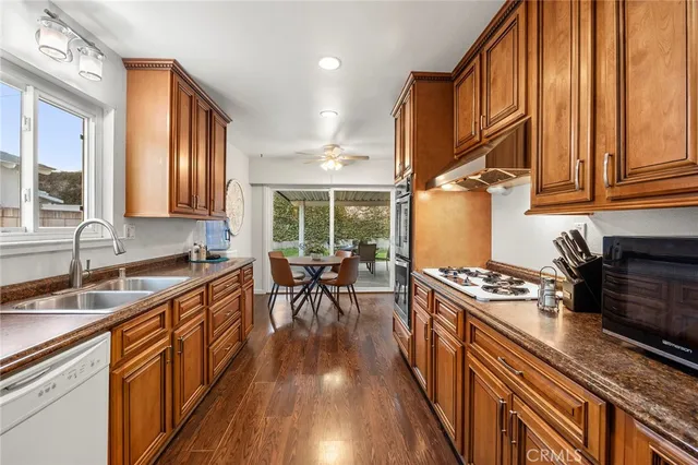 a kitchen with wooden cabinets and black appliances