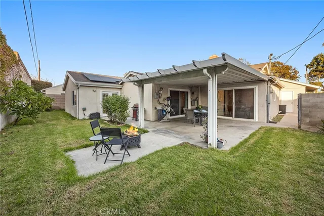 a view of a house with backyard porch and sitting area
