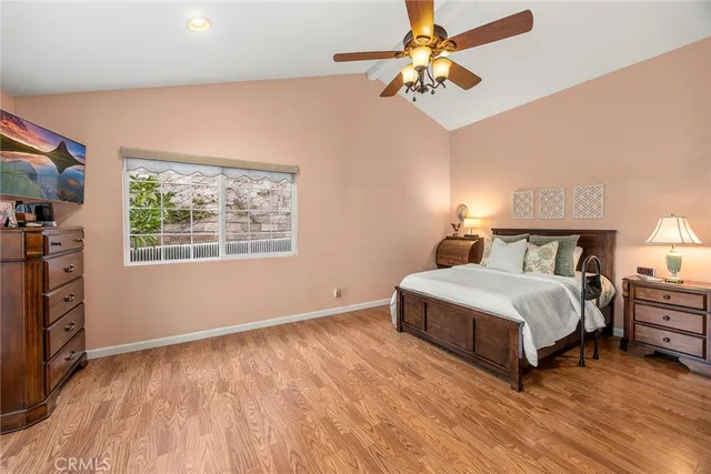 a spacious bedroom with a bed and a chandelier