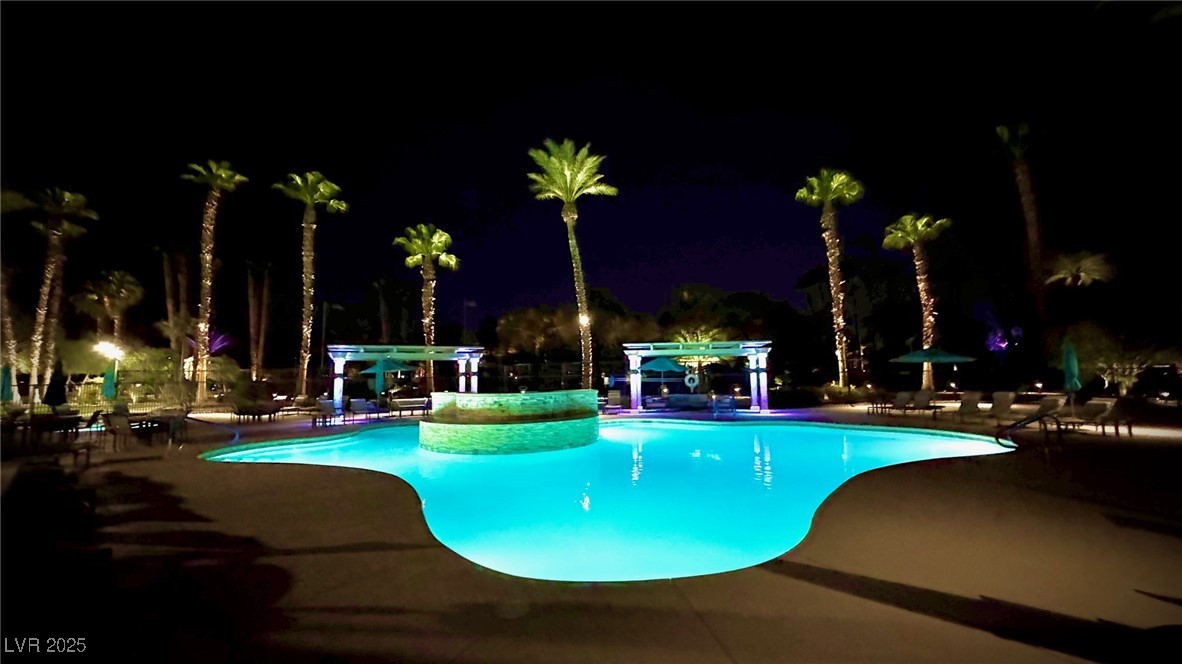 8175 Arville Street, Unit 210 Las Vegas, NV 89139 - Photo 27 of 36 Pool at night with an outdoor pool and a patio area
