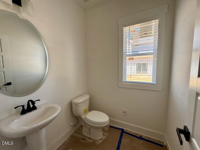 218 George Street Four Oaks, NC 27524 - Photo 19 of 50 a bathroom with a sink a toilet and a mirror