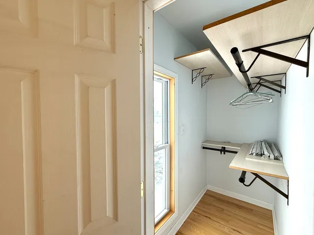 a view of a livingroom with wooden floor and staircase