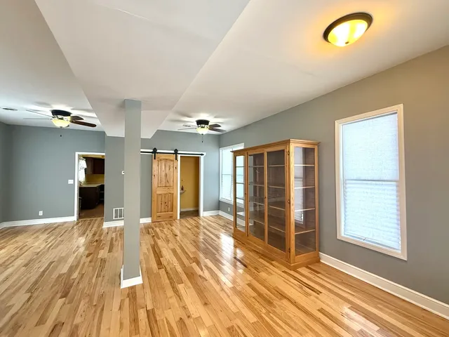 a view of a room with wooden floor and windows