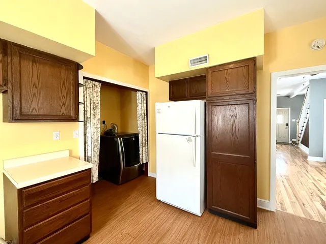 a kitchen with a refrigerator and a stove