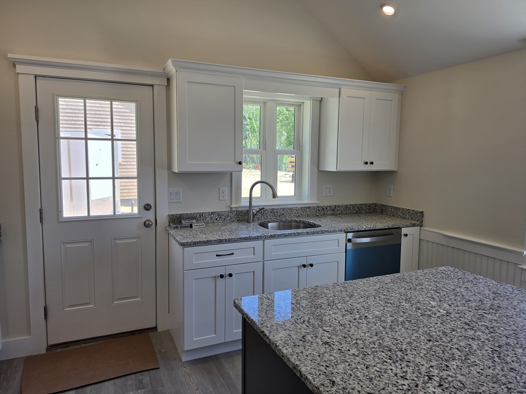 87 Acapesket Road, Unit 2A Falmouth, MA 02536 - Photo 7 of 17 a kitchen with granite countertop cabinets stainless steel appliances and a window