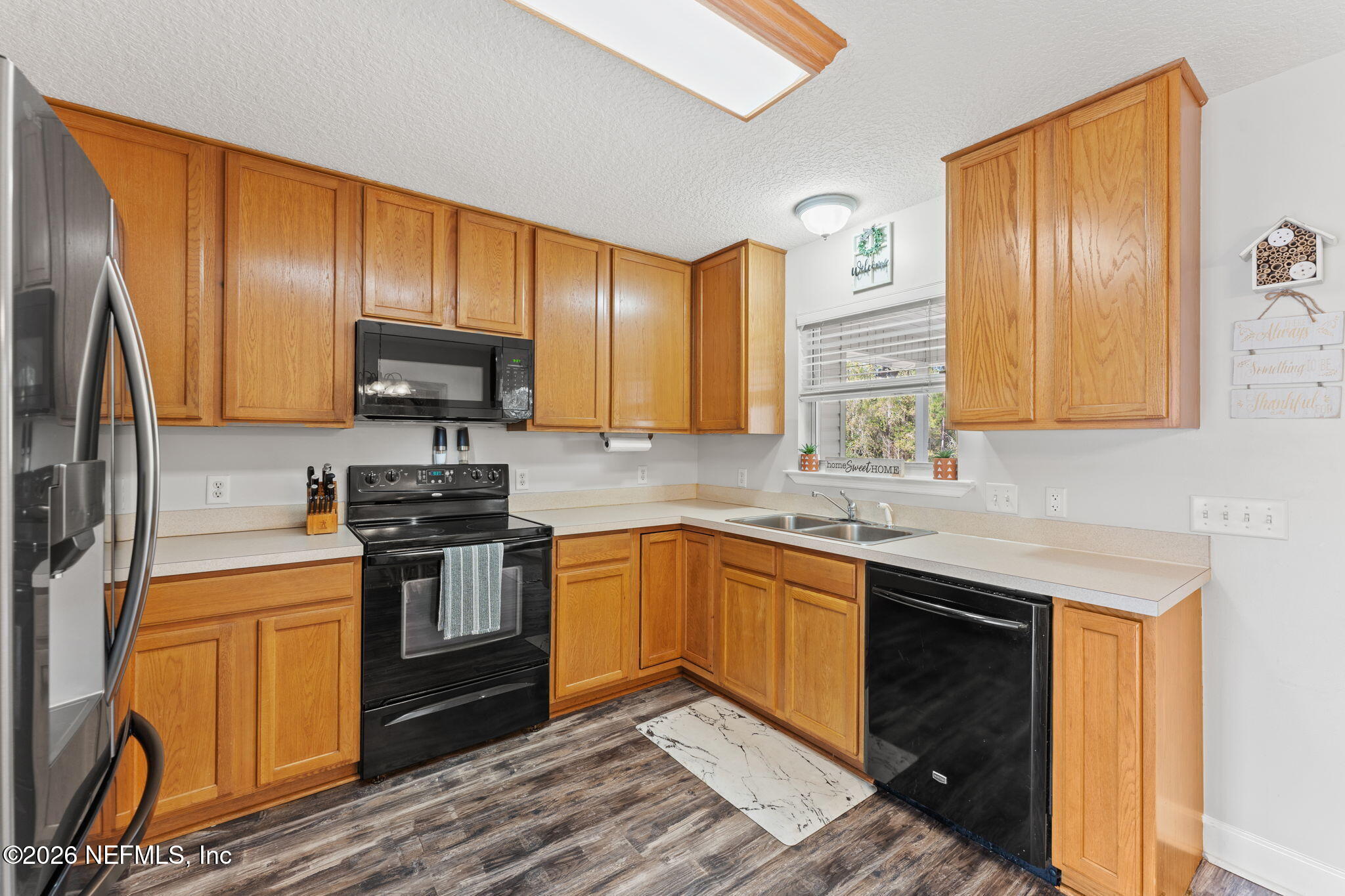 482 North 3rd Street Macclenny, FL 32063 - Photo 11 of 32 a kitchen with stainless steel appliances granite countertop wooden cabinets a stove top oven a sink and dishwasher