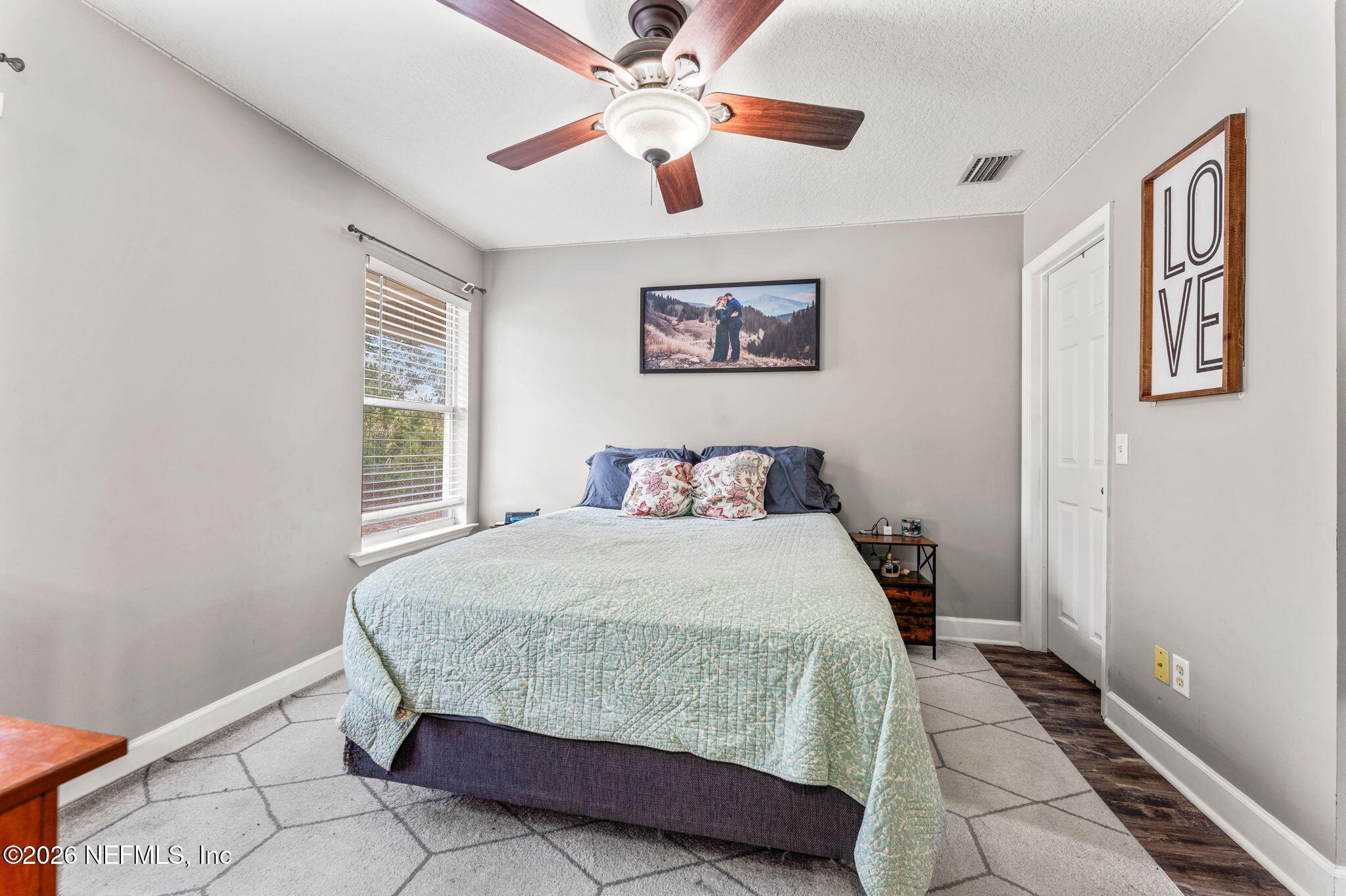 482 North 3rd Street Macclenny, FL 32063 - Photo 13 of 32 a bedroom with a large bed and a window