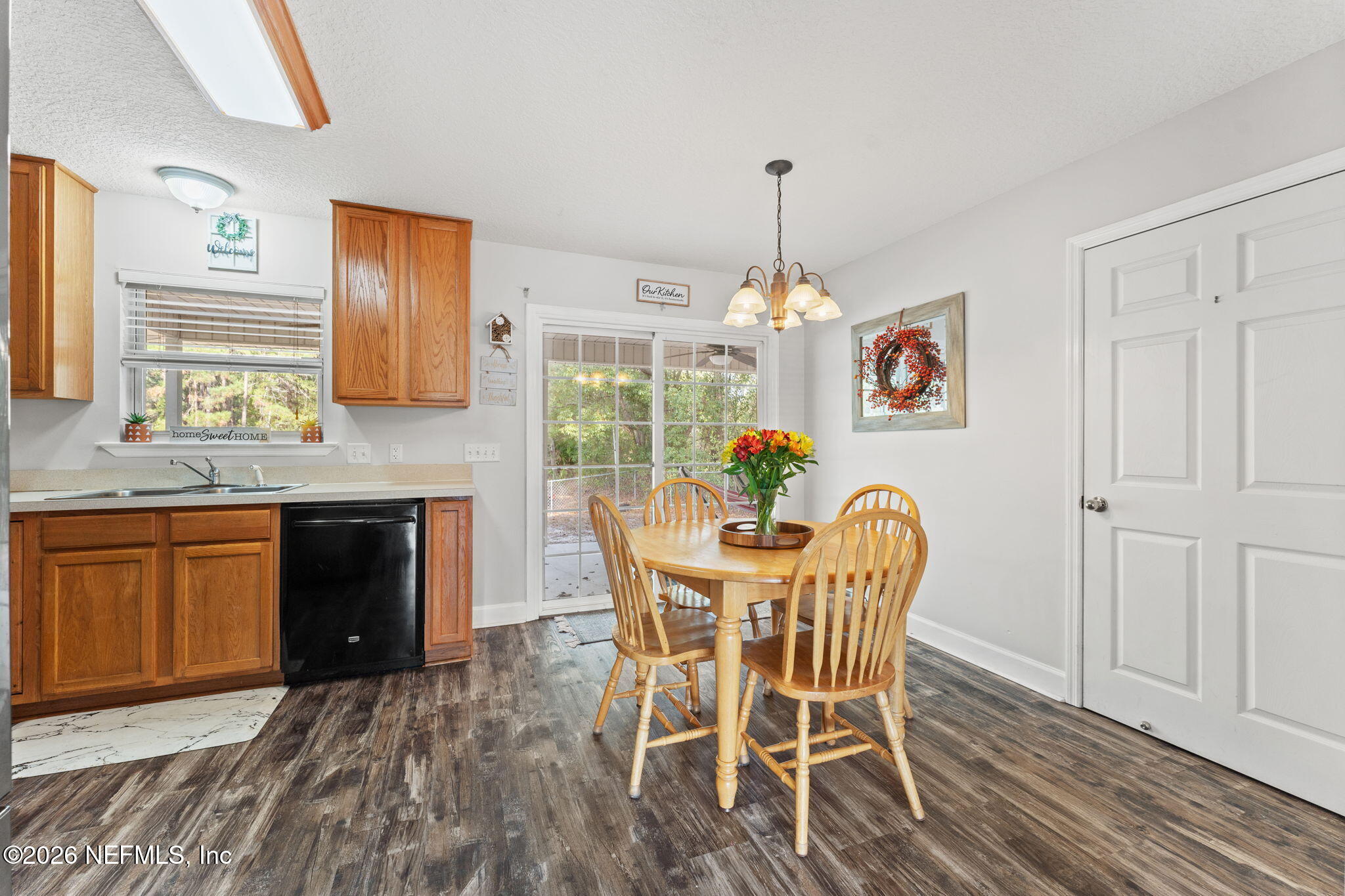 482 North 3rd Street Macclenny, FL 32063 - Photo 7 of 32 a dining room with furniture a chandelier and wooden floor