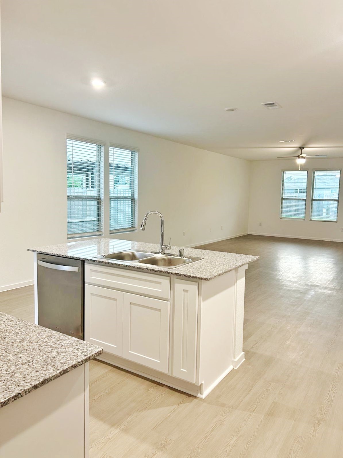 14973 Rustic Moon Road Conroe, TX 77302 - Photo 3 of 22 a kitchen with granite countertop a sink and a stove
