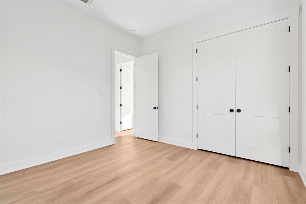 8008 Ben Day Murrin Road Fort Worth, TX 76126 - Photo 28 of 40 a view of an empty room with wooden floor