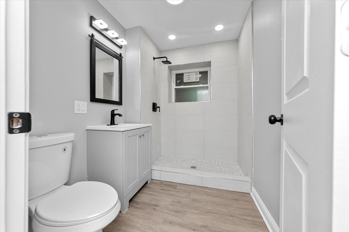 7819 South Morgan Street, Unit G Chicago, IL 60620 - Photo 9 of 13 a bathroom with a toilet a sink and mirror