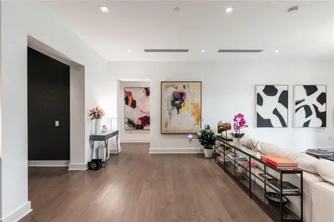 a living room with furniture and view of kitchen