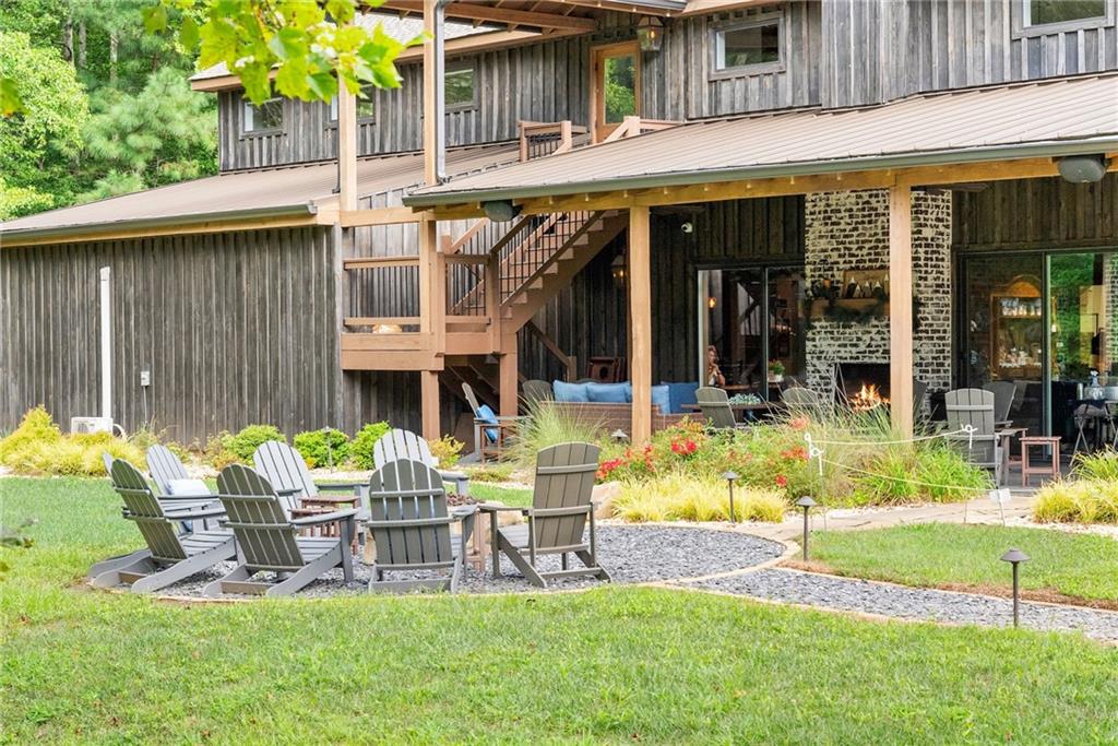 253 Happy Trails Way Jasper, GA 30143 - Photo 7 of 97 a view of a chair and table in backyard of the house