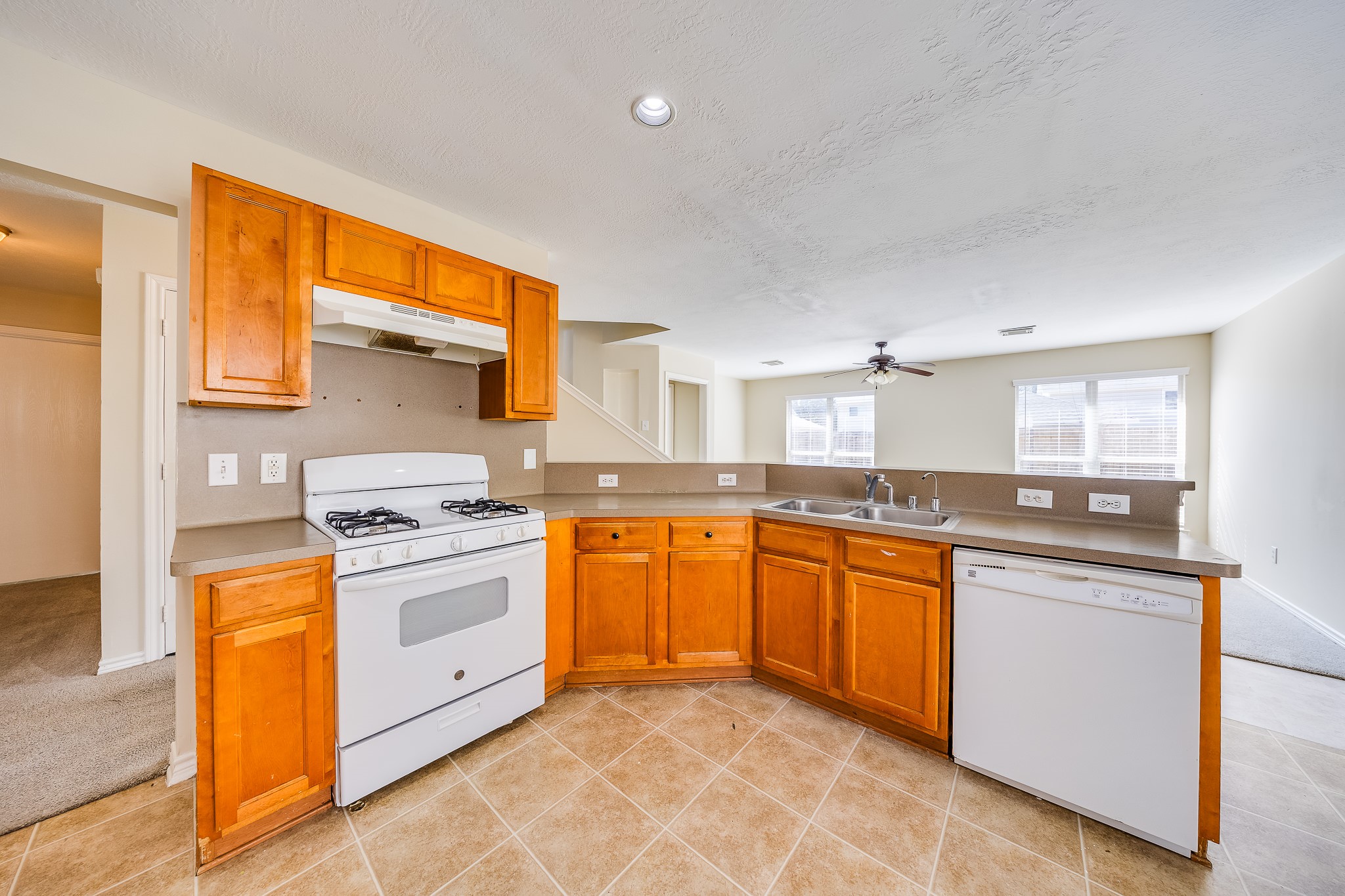 20003 Rustic Lake Lane Cypress, TX 77433 - Photo 5 of 21 a kitchen with stainless steel appliances granite countertop a stove a sink dishwasher and a refrigerator