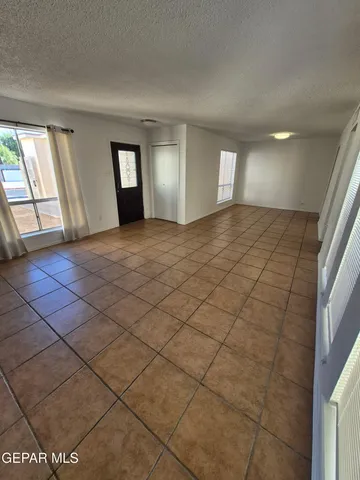 a kitchen with granite countertop a stove sink and cabinets