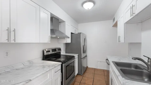 a kitchen with cabinets and stainless steel appliances