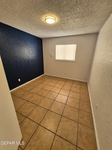 an empty room with a carpet