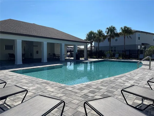a view of a house with swimming pool and a yard