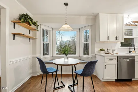 a kitchen with stainless steel appliances granite countertop a refrigerator sink and white cabinets