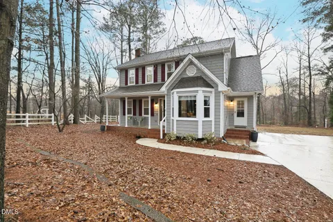 a view of a hallway with wooden floor windows and a livingroom