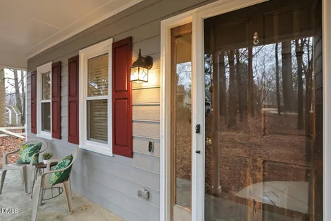 a living room with furniture a fireplace and a window