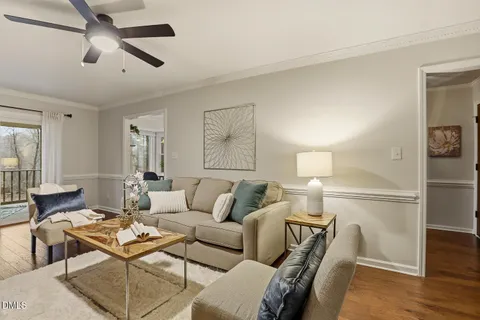 a view of a bedroom with wooden floor and windows
