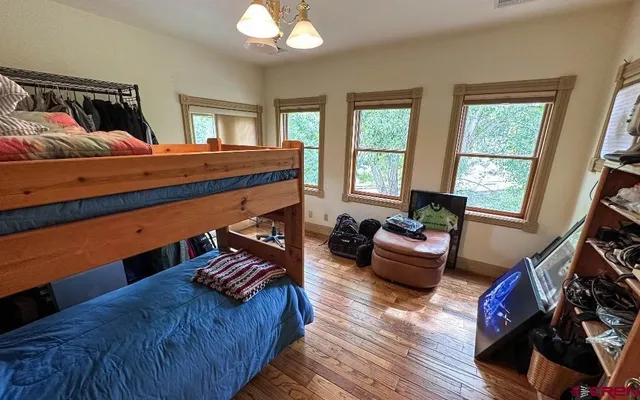 a bedroom with furniture and a large window