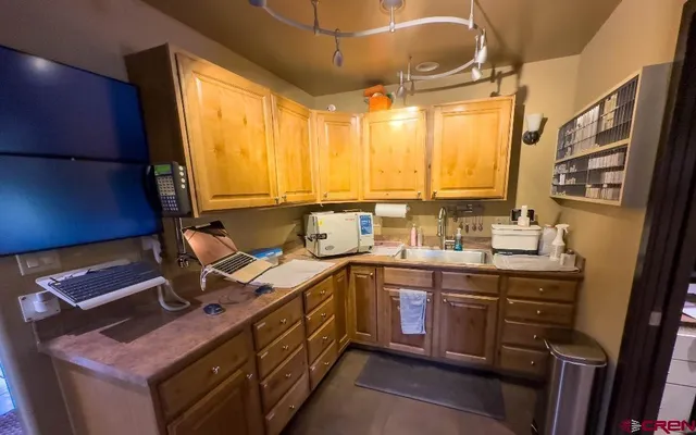 a kitchen with a sink stove and cabinets
