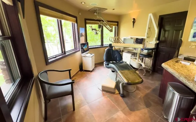 a room with lots of windows and furniture