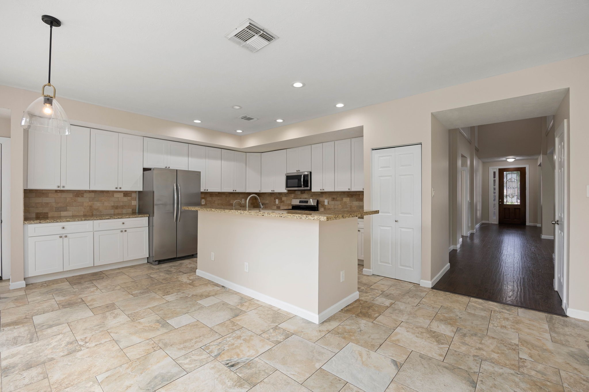 6335 Borg Breakpoint Drive Spring, TX 77379 - Photo 8 of 39 Spacious kitchen featuring abundant cabinetry, generous counter space, and a large center island.
