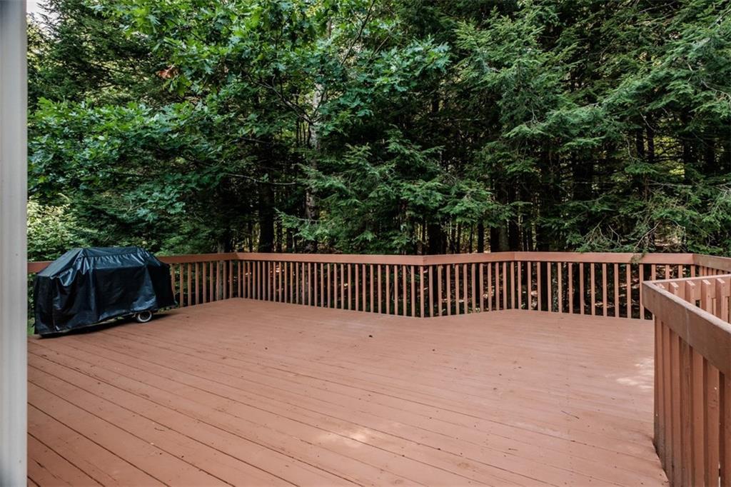 55 Woodland Road Durham, ME 04222 - Photo 3 of 29 The large deck overlooks the woods.