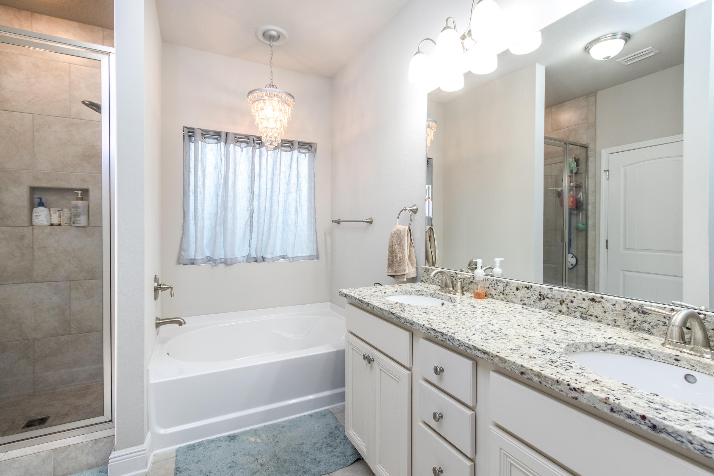 196 Pin Oak Loop Santa Rosa Beach, FL 32459 - Photo 17 of 34 a bathroom with a granite countertop sink tub and a mirror