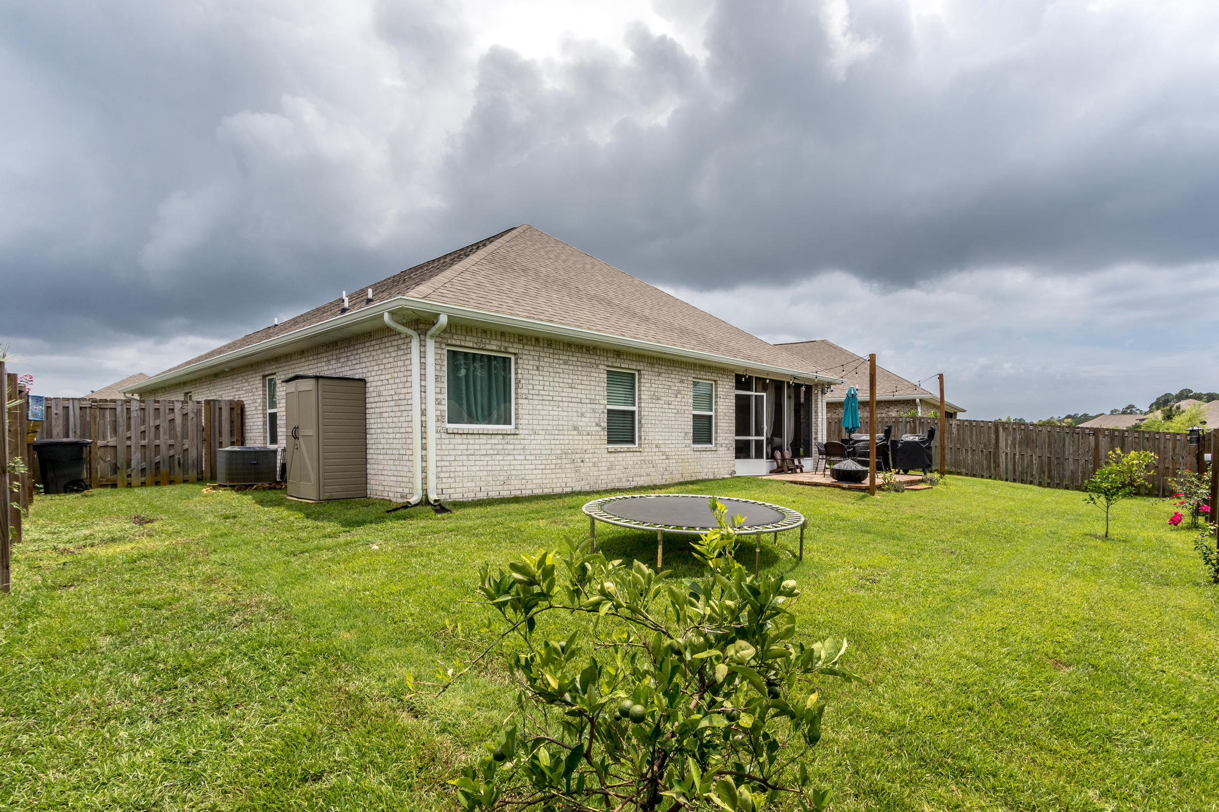 196 Pin Oak Loop Santa Rosa Beach, FL 32459 - Photo 26 of 34 a backyard of a house with table and chairs