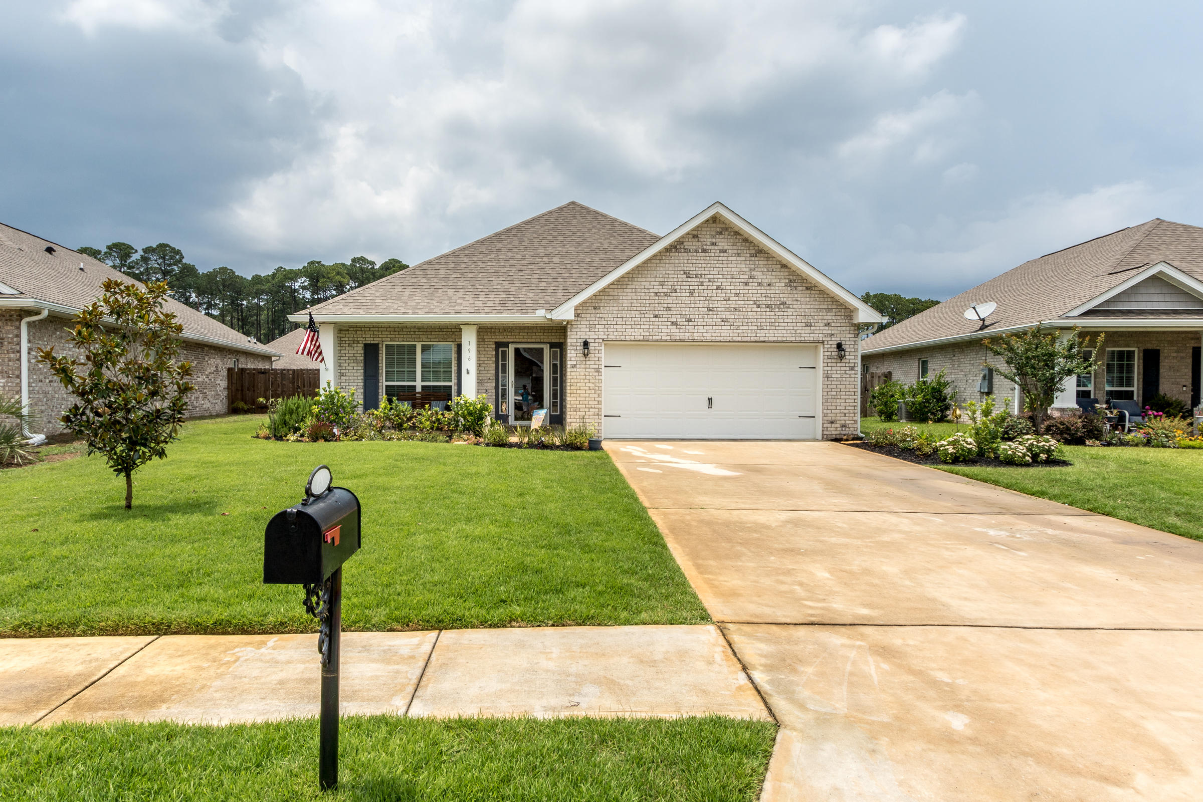 196 Pin Oak Loop Santa Rosa Beach, FL 32459 - Photo 3 of 34 a front view of house with yard and green space